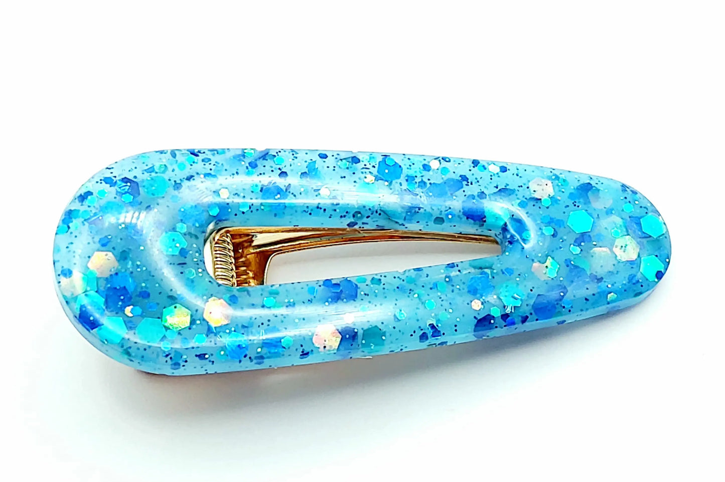Barrette arrondie en résine époxy, bleu et paillettes holographiques.