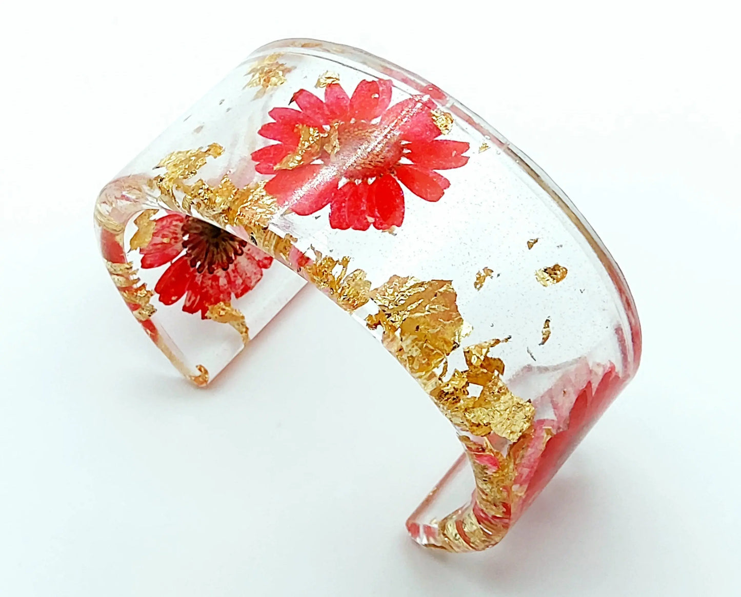 Manchette en résine époxy. Fleurs rouges et feuille d'or.