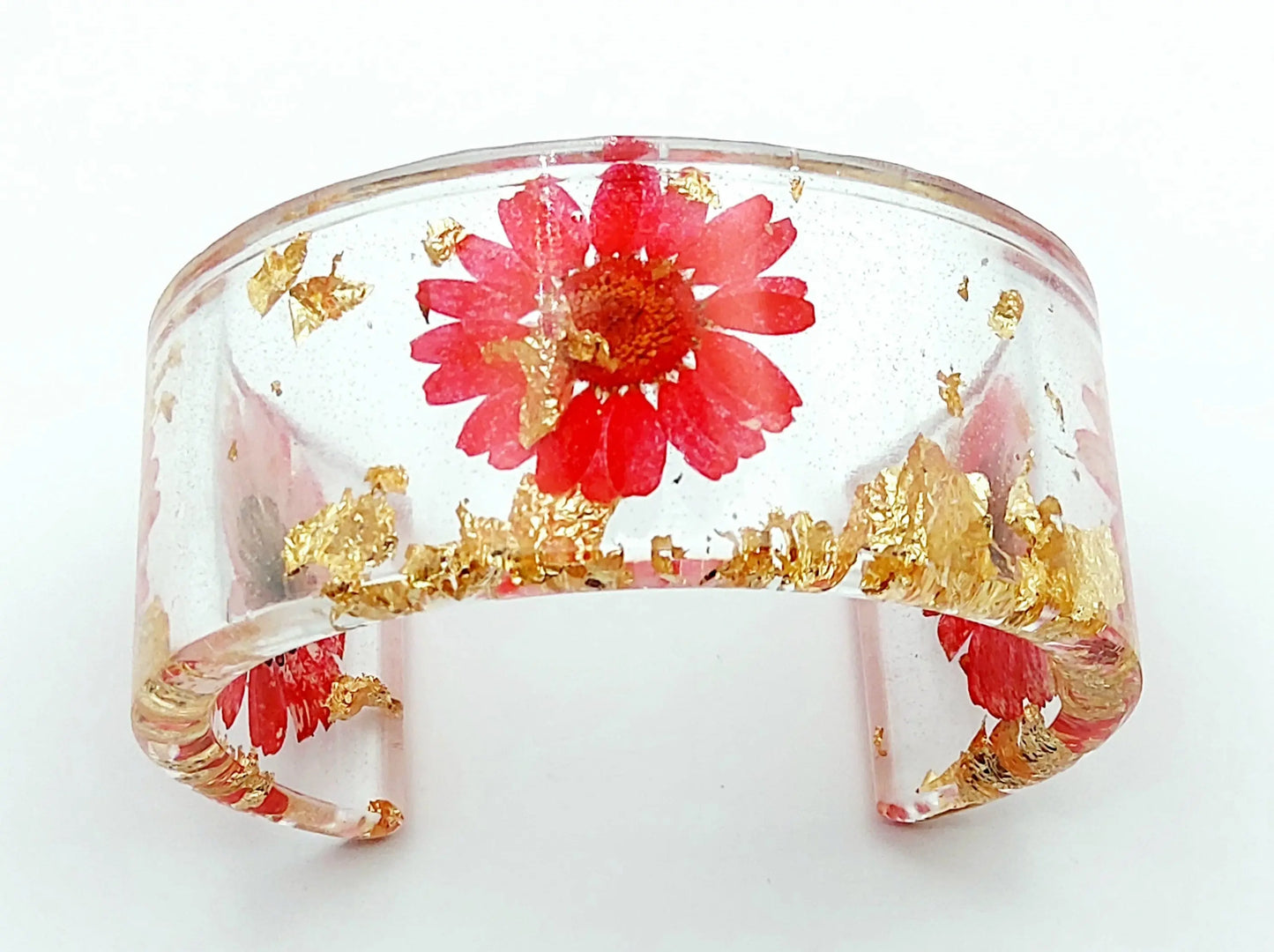 Manchette en résine époxy. Fleurs rouges et feuille d'or.