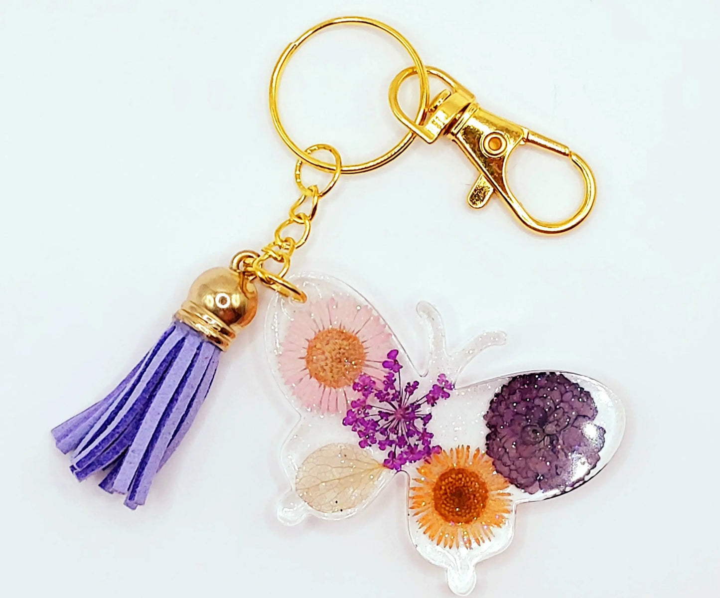 Porte-clés "Papillon" en résine époxy. Fleurs multicolores. Anneau et mousqueton doré.