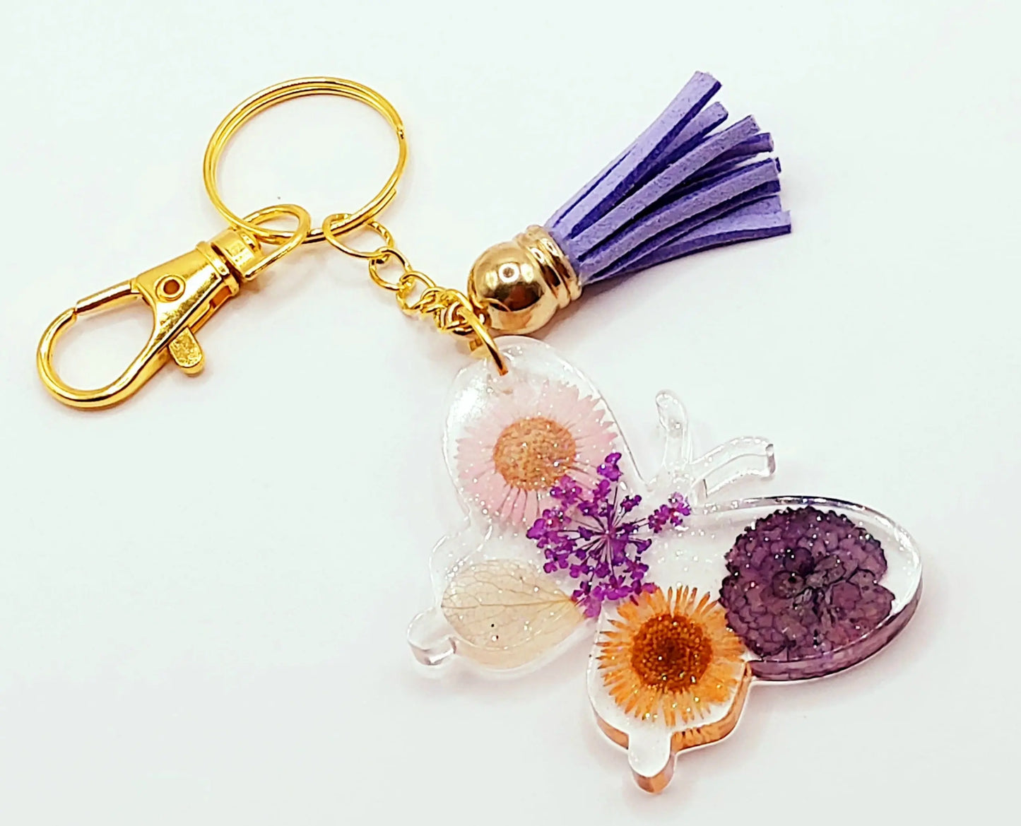Porte-clés "Papillon" en résine époxy. Fleurs multicolores. Anneau et mousqueton doré.