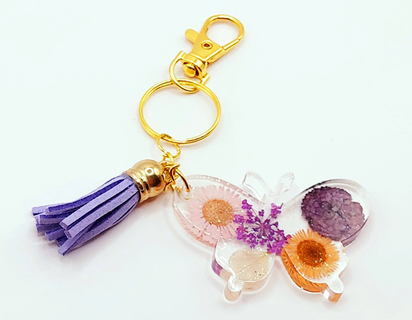 Porte-clés "Papillon" en résine époxy. Fleurs multicolores. Anneau et mousqueton doré.