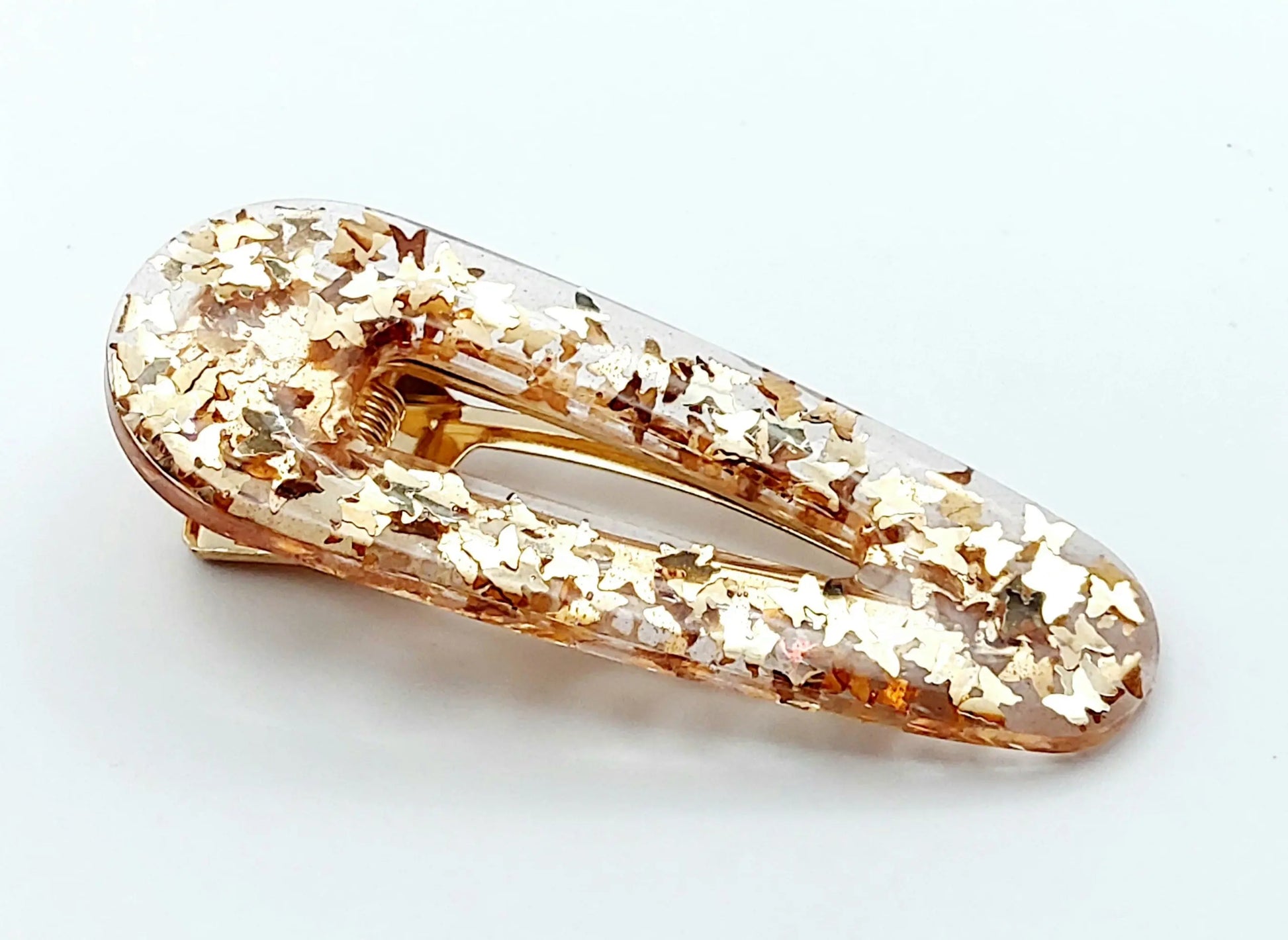 Barrette "Arrondie" en résine époxy, paillettes papillons dorées.