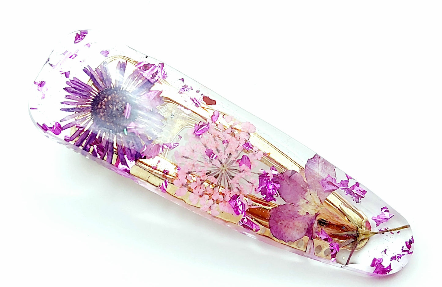 Barrette "arrondie" en résine époxy. Fleurs séchées rose et violettes.