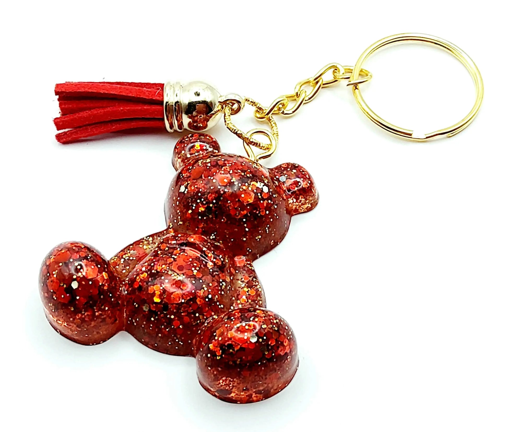 Porte-clés "Ourson assis" en résine époxy. Paillettes rouges et or. Anneau doré. Pompon gland rouge.