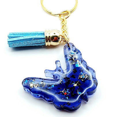 Porte-clés "Papillon" en résine époxy. Bleu et feuille d'or. Anneau doré. Pompon gland bleu ciel.