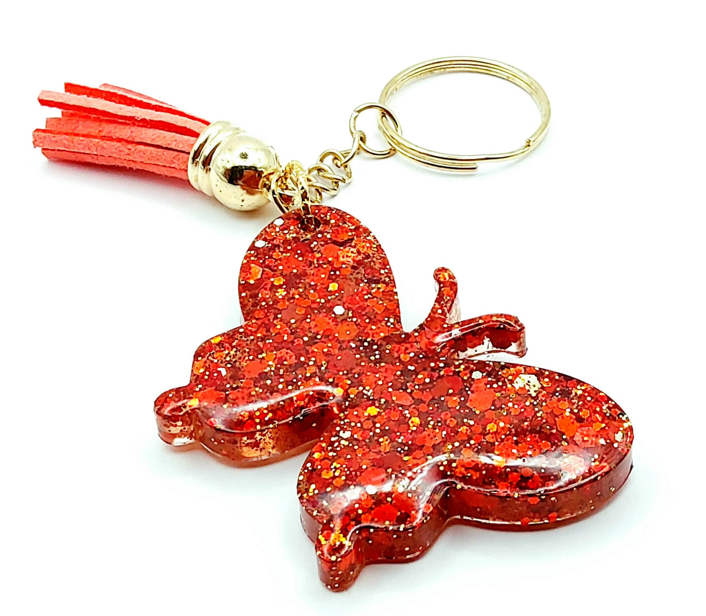 Porte-clés "Papillon" en résine époxy. Paillettes rouges, anneau doré, pompon gland rouge.