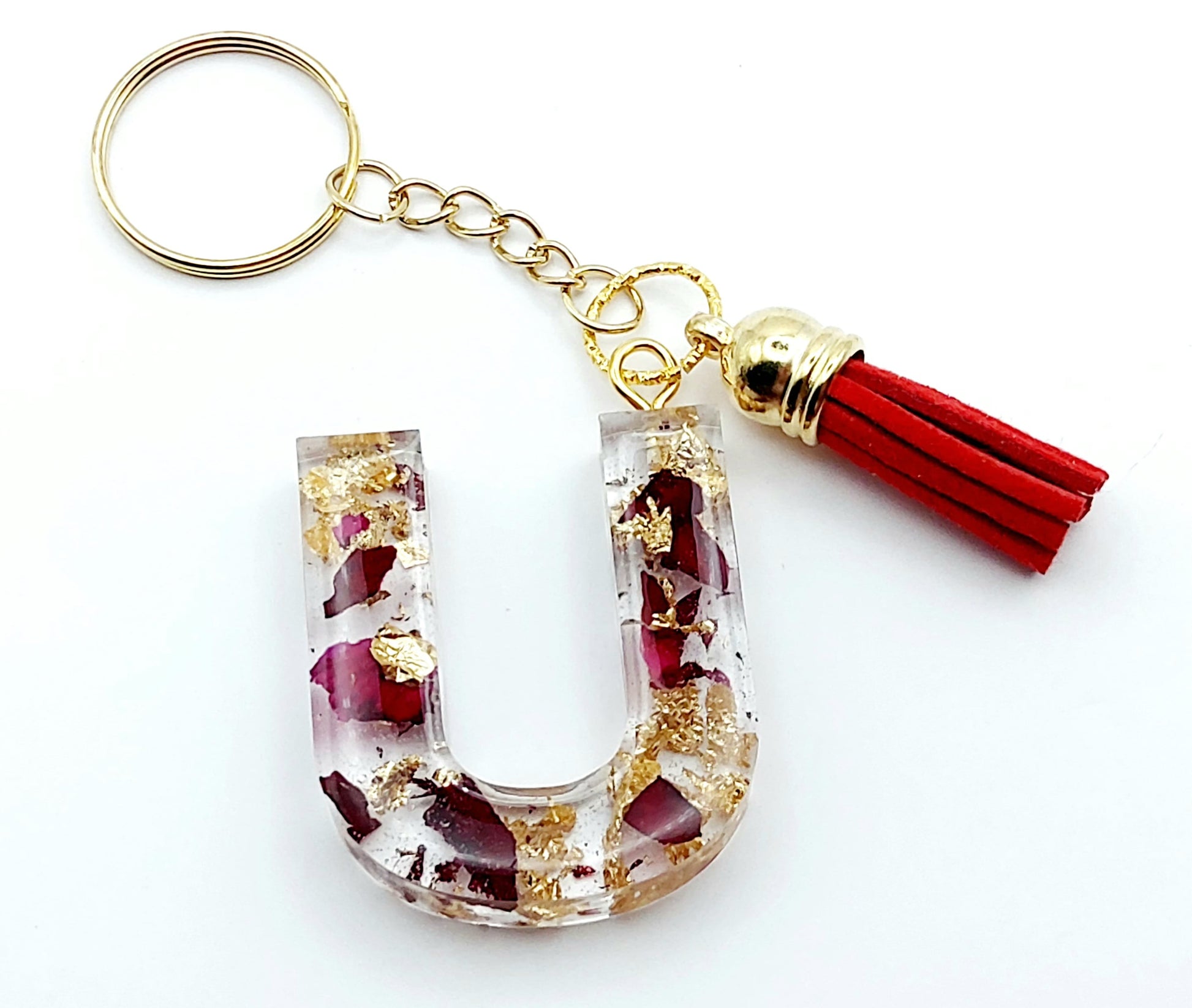 Porte-clés "Lettre U" en résine époxy, pétales de roses et feuille d'or, pompon gland rouge, anneau doré.